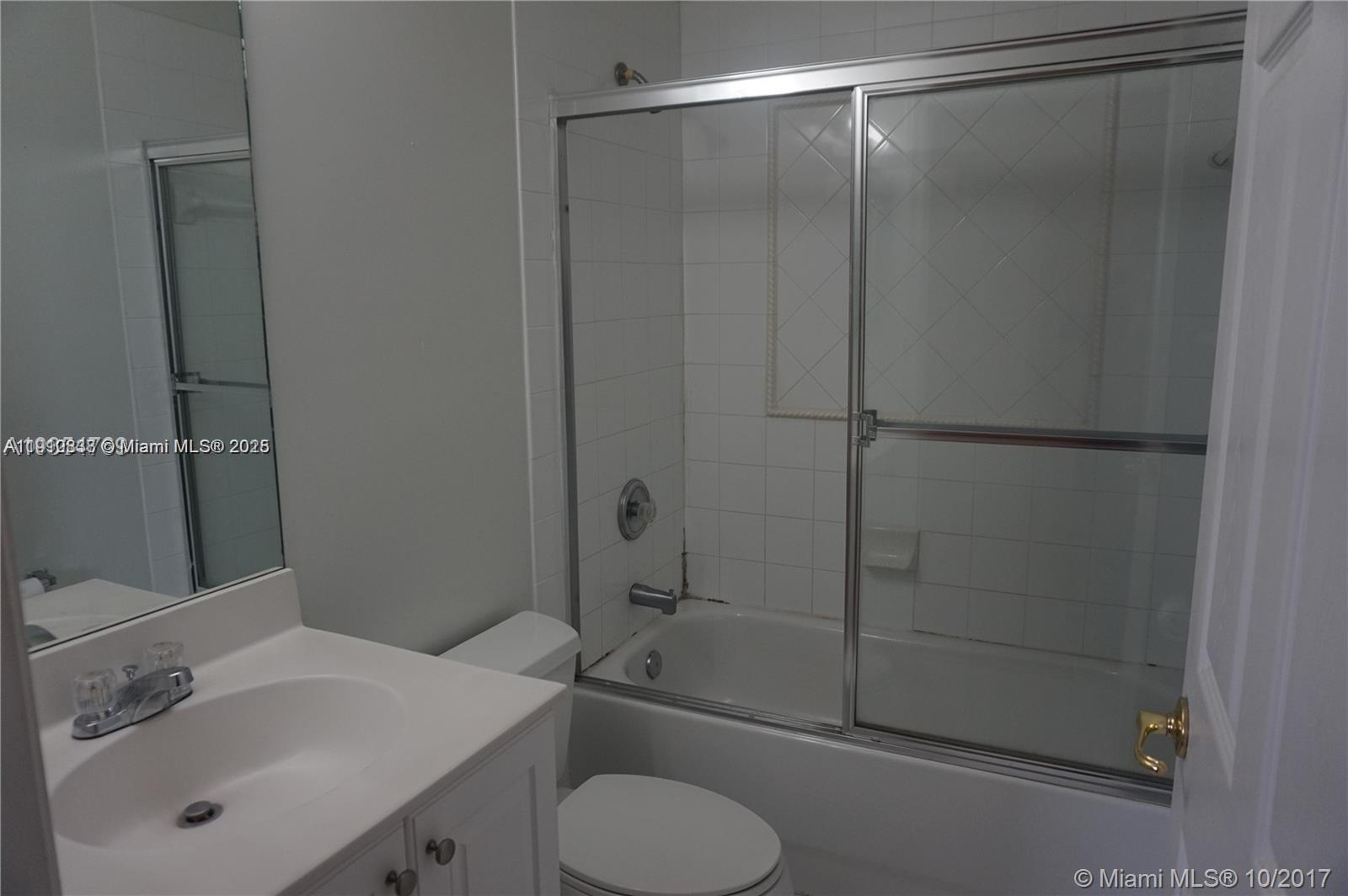 2551 Southwest 83rd Avenue, Unit 107 Miramar, FL 33025 - Photo 3 of 19 a bathroom with a shower sink vanity and toilet
