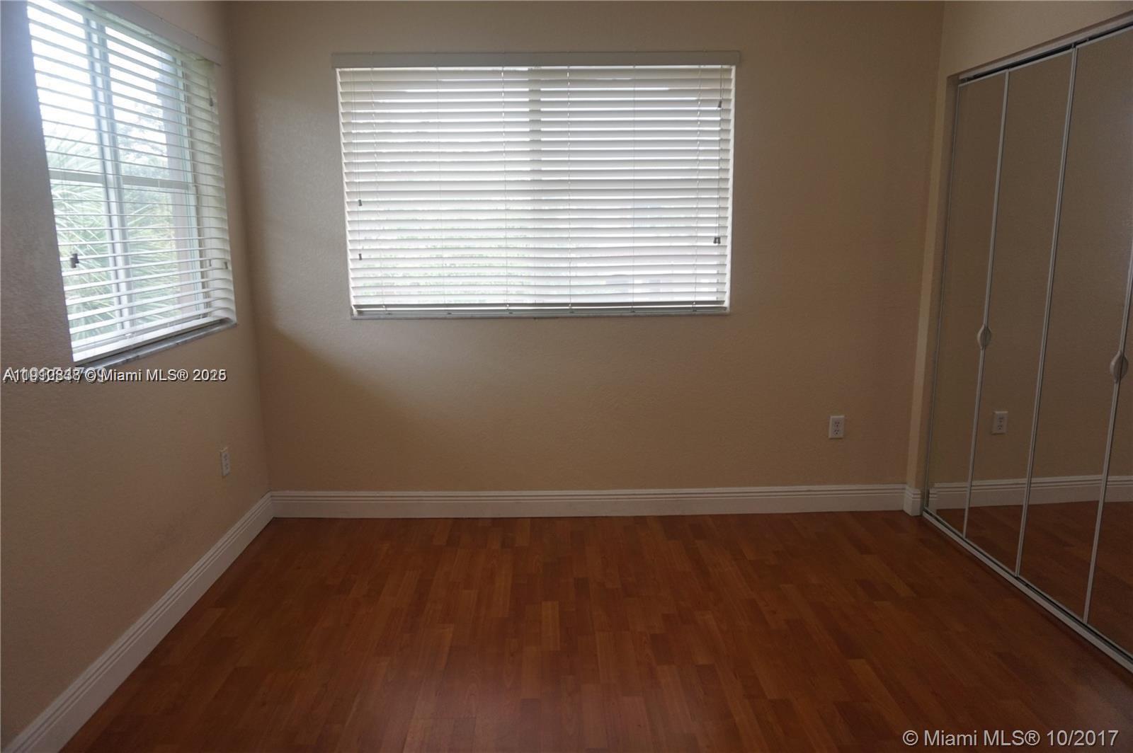 2551 Southwest 83rd Avenue, Unit 107 Miramar, FL 33025 - Photo 6 of 19 an empty room with a window