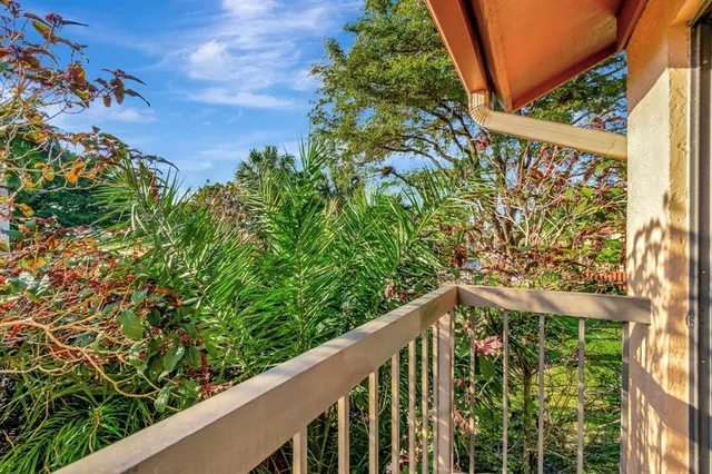 a couple of palm trees in front of yellow house