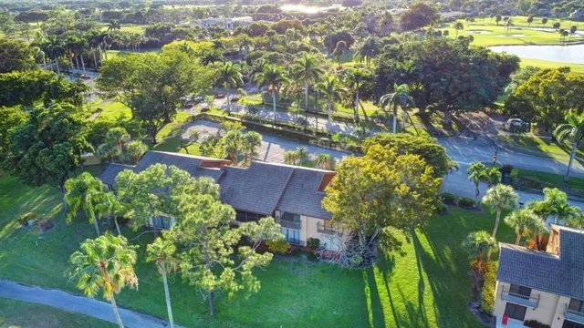 an aerial view of a city with lots of residential buildings and mountain view in back