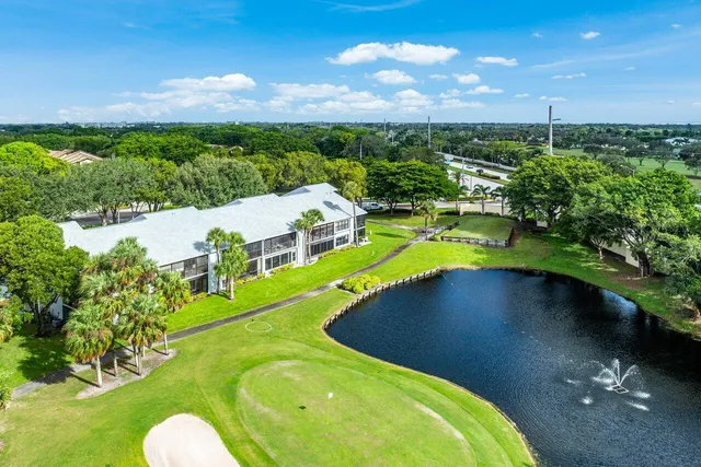 an aerial view of a house with swimming pool a yard and outdoor seating