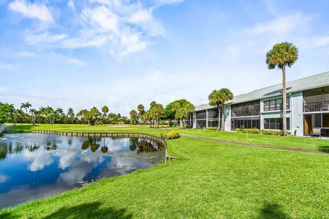 a view of a swimming pool with outdoor seating and a garden