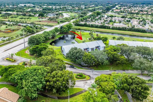 a living room with lots of furniture a chandelier and a large window