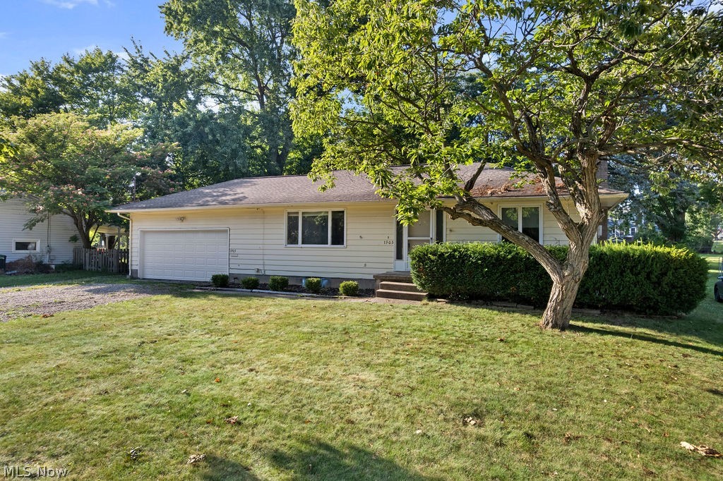 1903 Graham Road Stow, OH 44224 - Photo 2 of 29 Single-story residence featuring a front yard with mature landscaping and a prominent tree