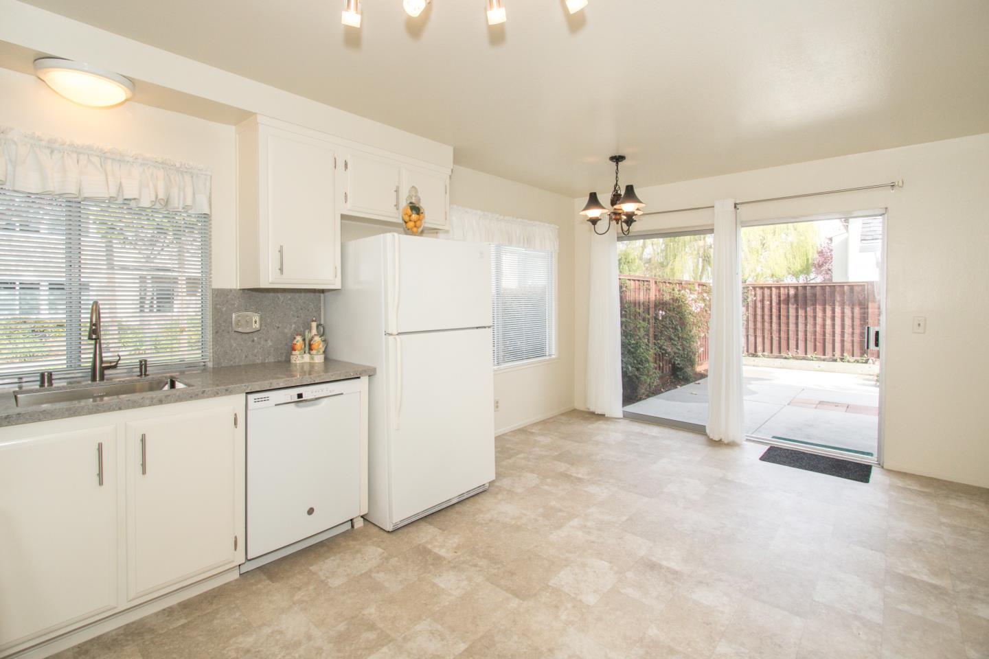 740 Pinta Lane Foster City, CA 94404 - Photo 11 of 33 a kitchen with refrigerator a sink and cabinets