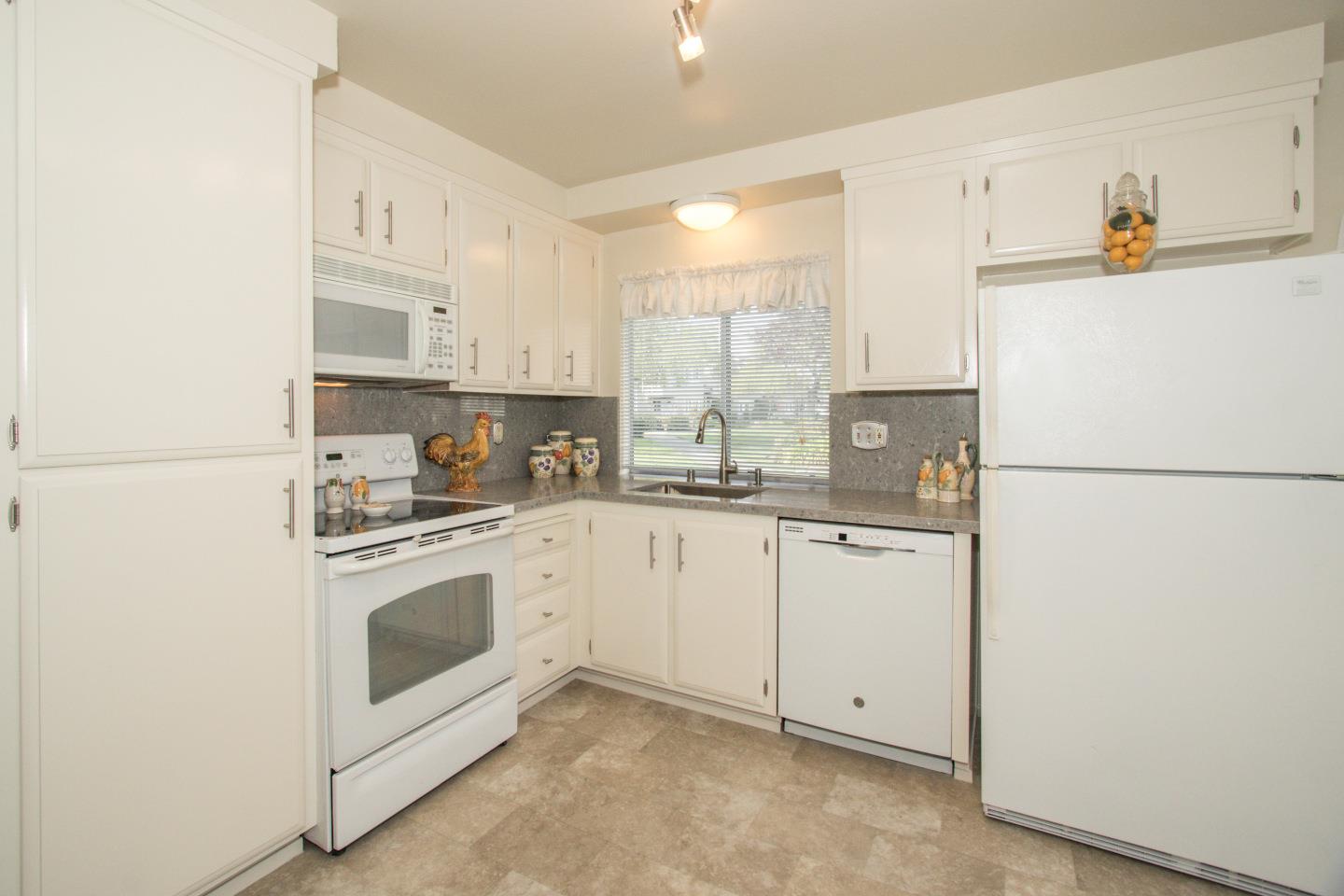 740 Pinta Lane Foster City, CA 94404 - Photo 12 of 33 a kitchen with white cabinets and white appliances