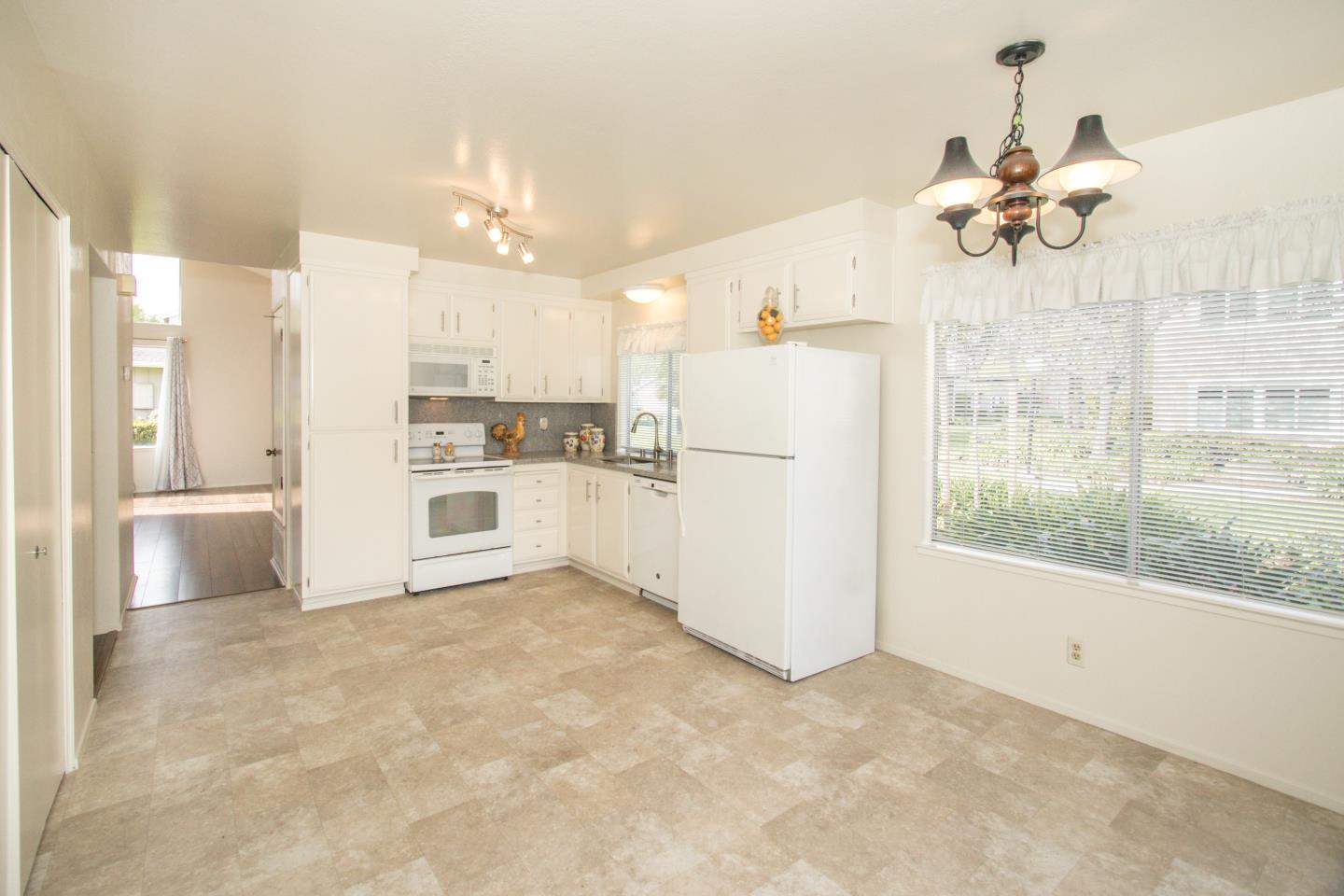 740 Pinta Lane Foster City, CA 94404 - Photo 13 of 33 a view of a kitchen with a refrigerator and a stove top oven