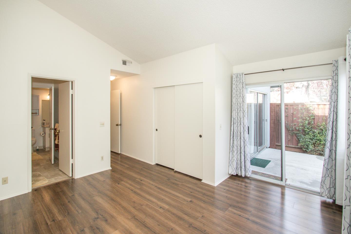 740 Pinta Lane Foster City, CA 94404 - Photo 22 of 33 a view of an empty room with wooden floor and a window
