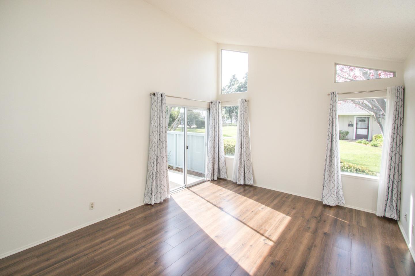 740 Pinta Lane Foster City, CA 94404 - Photo 7 of 33 an empty room with wooden floor and windows