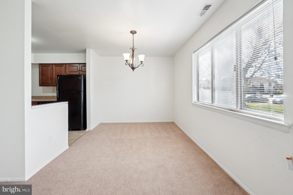 58 Sandra Road Voorhees, NJ 08043 - Photo 4 of 25 an empty room with a fireplace and windows