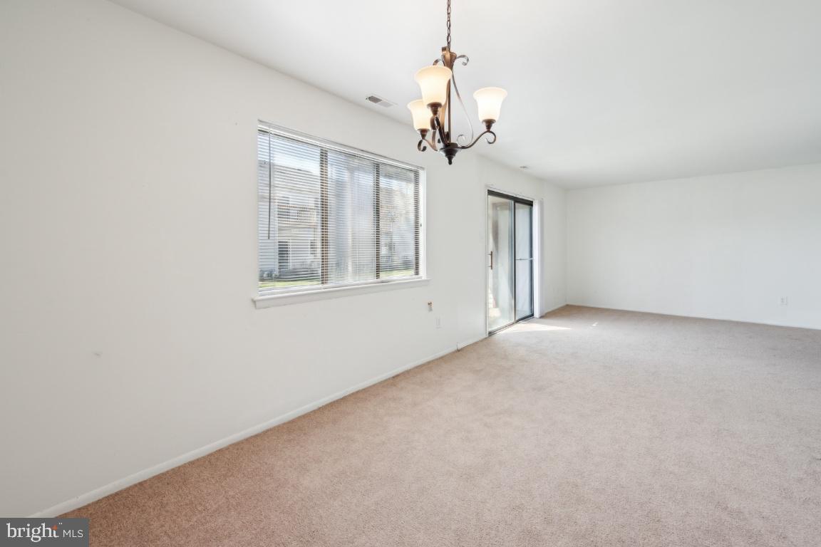 58 Sandra Road Voorhees, NJ 08043 - Photo 6 of 25 a view of a livingroom with a chandelier fan and windows