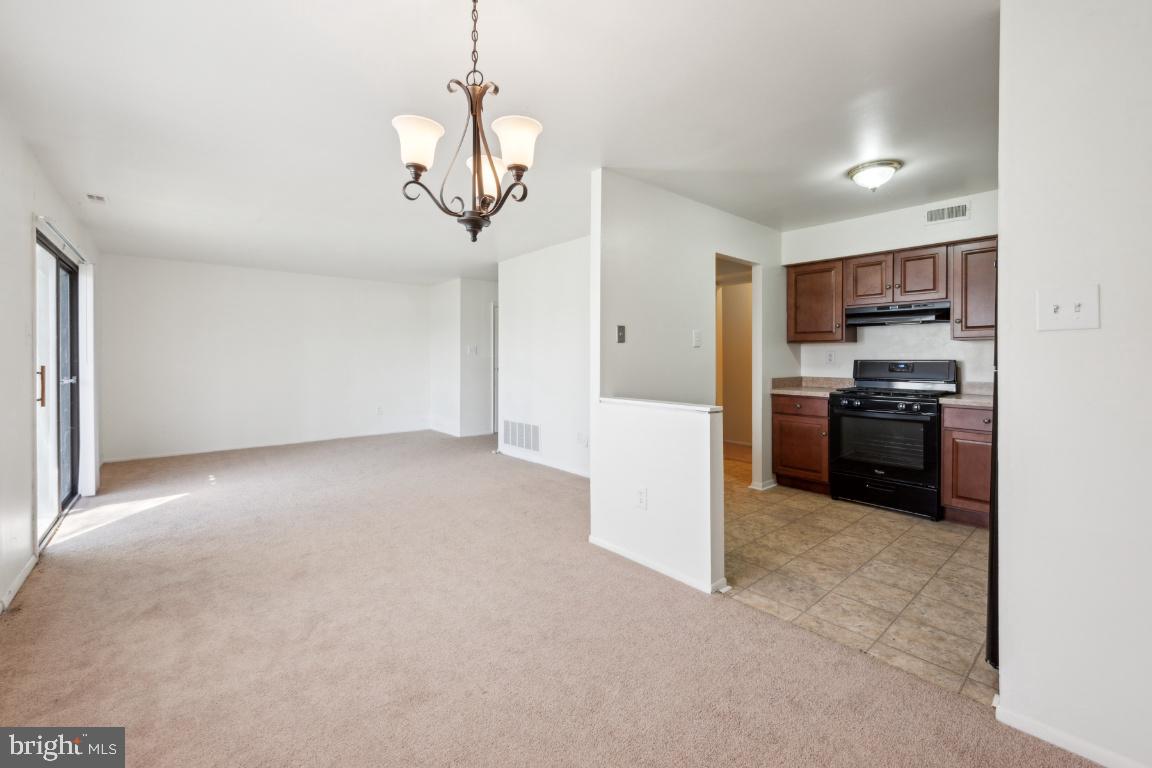 58 Sandra Road Voorhees, NJ 08043 - Photo 7 of 25 a view of a kitchen with a sink and dishwasher a refrigerator with wooden floor
