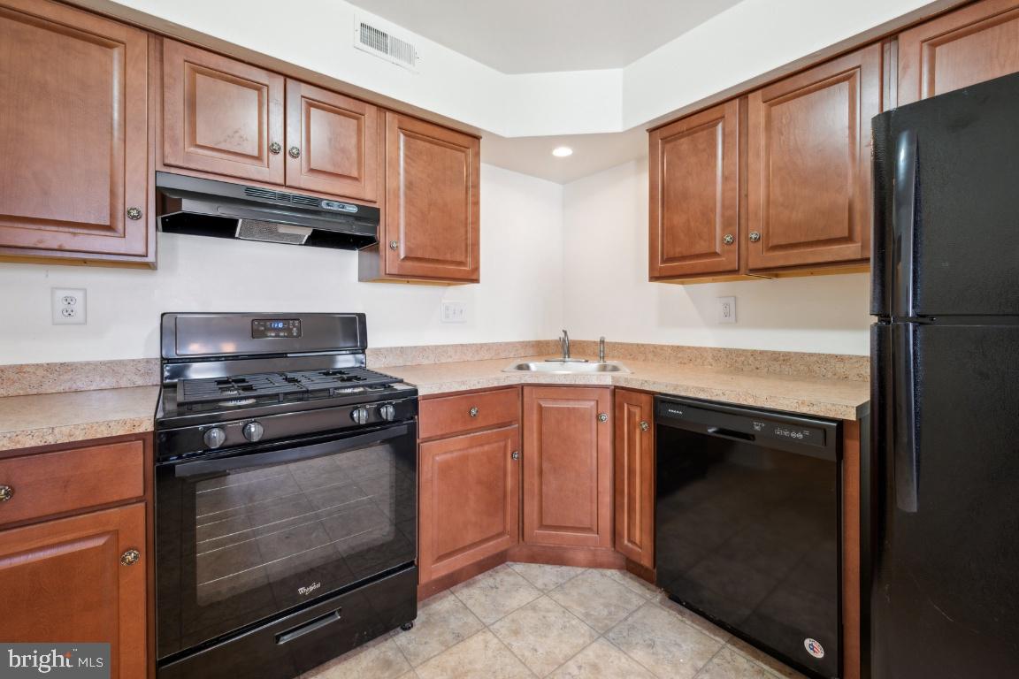 58 Sandra Road Voorhees, NJ 08043 - Photo 8 of 25 a kitchen with stainless steel appliances granite countertop a stove microwave and refrigerator