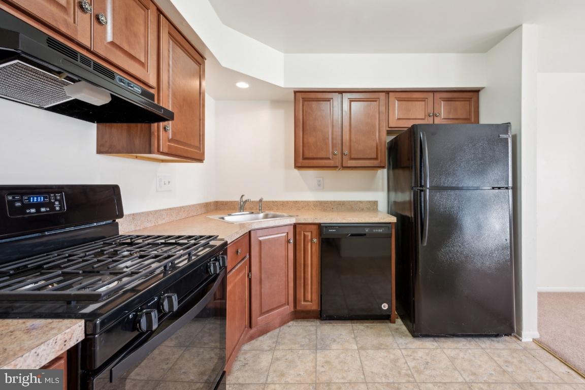 58 Sandra Road Voorhees, NJ 08043 - Photo 9 of 25 a kitchen with a stove a refrigerator and a cabinets