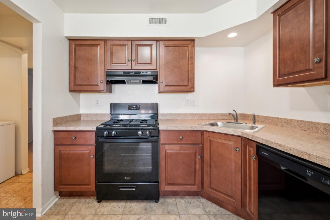 58 Sandra Road Voorhees, NJ 08043 - Photo 10 of 25 a kitchen with a stove and a sink