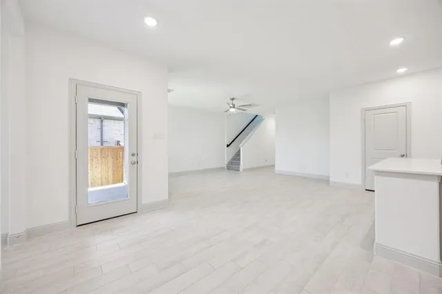 an empty room with a fireplace and windows
