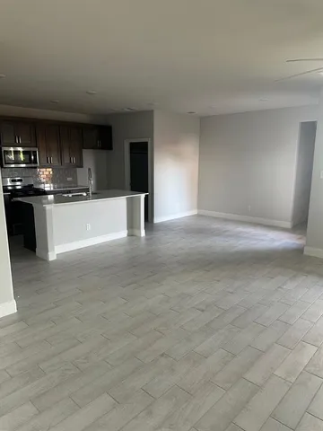 a view of kitchen with refrigerator sink and stove