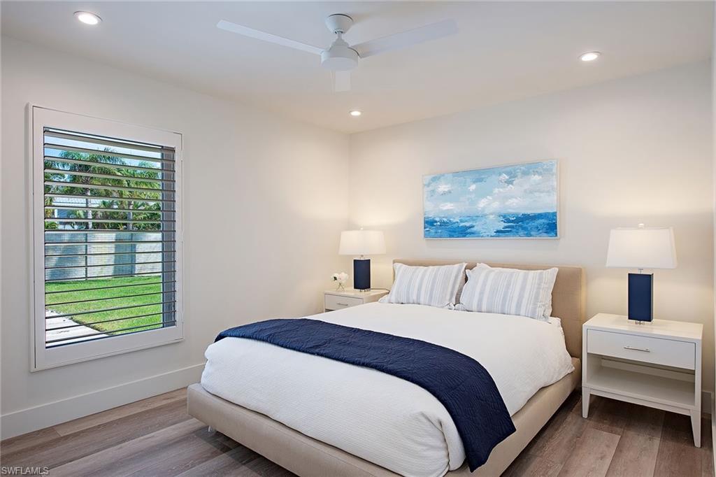 1600 Murex Lane Naples, FL 34102 - Photo 17 of 25 a bedroom with a large bed and a window