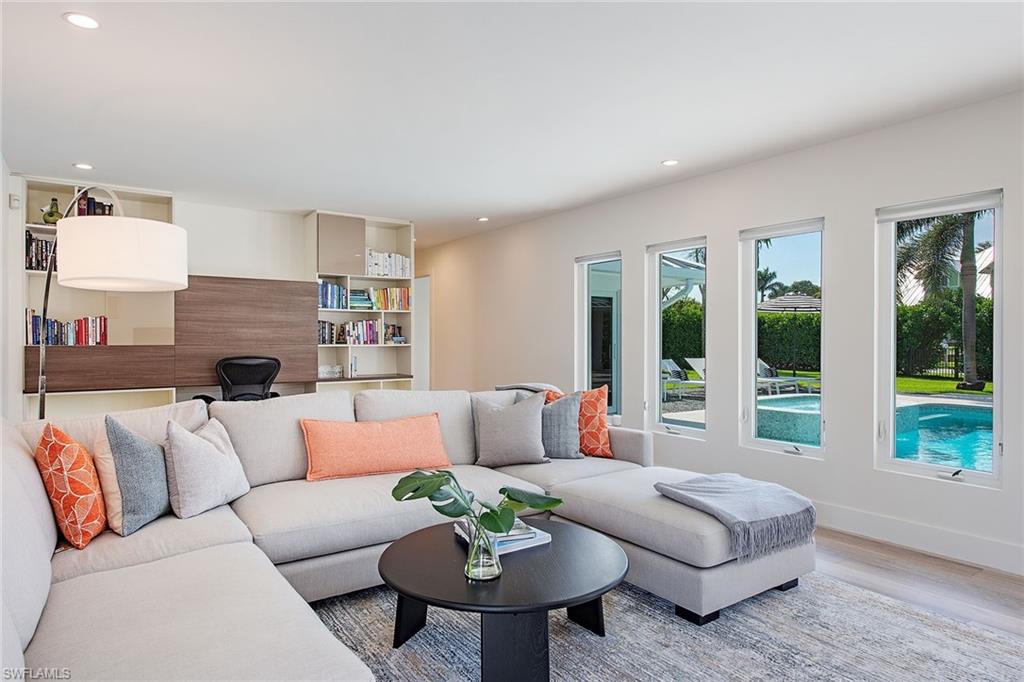 1600 Murex Lane Naples, FL 34102 - Photo 18 of 25 a living room with furniture and a fireplace