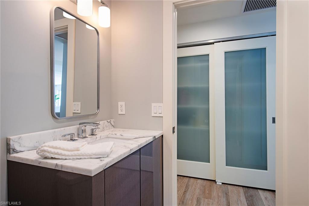 1600 Murex Lane Naples, FL 34102 - Photo 20 of 25 a bathroom with a sink and a mirror