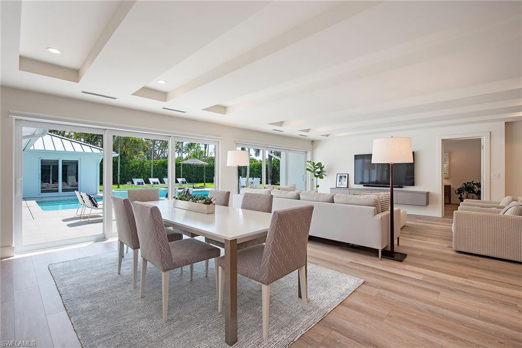 1600 Murex Lane Naples, FL 34102 - Photo 7 of 25 a dining room with furniture window and wooden floor