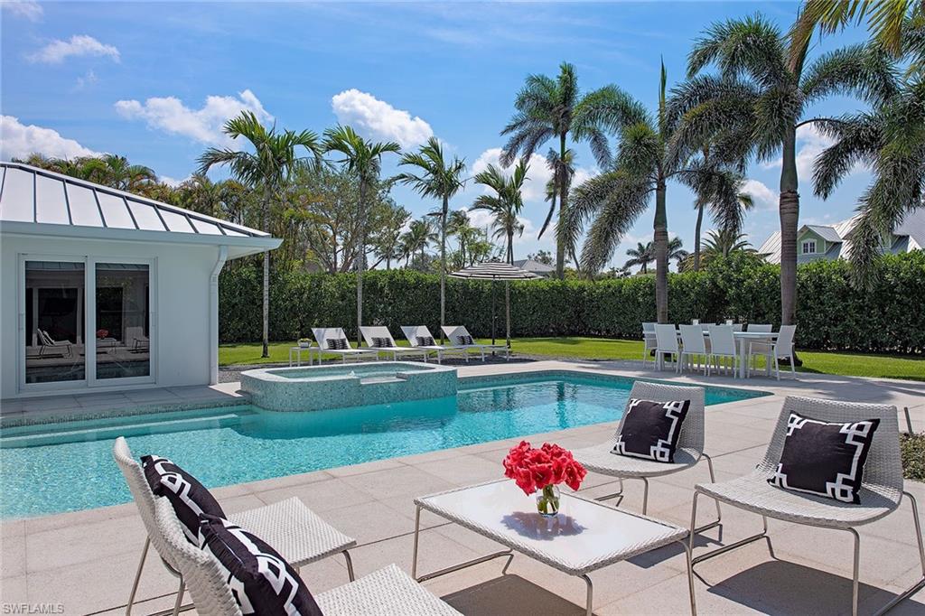 1600 Murex Lane Naples, FL 34102 - Photo 9 of 25 a swimming pool with outdoor seating and yard