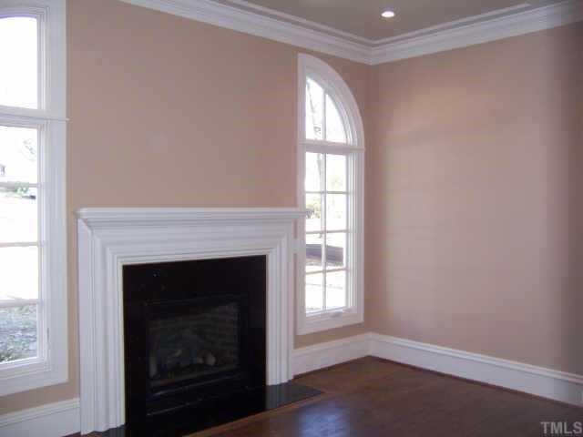 421 Yarmouth Road Raleigh, NC 27608 - Photo 3 of 12 a living room with a fireplace and a window