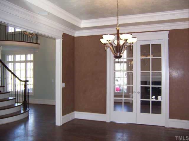 421 Yarmouth Road Raleigh, NC 27608 - Photo 4 of 12 a view of a livingroom with wooden floor and entryway
