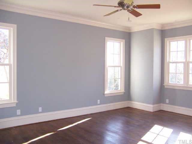 421 Yarmouth Road Raleigh, NC 27608 - Photo 8 of 12 a view of an empty room with wooden floor and a window