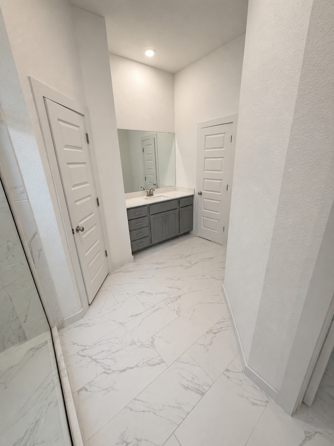1213 Bryson Rdg Trail Leander, TX 78641 - Photo 11 of 16 A refined bathroom features a spacious vanity and elegant tile flooring.