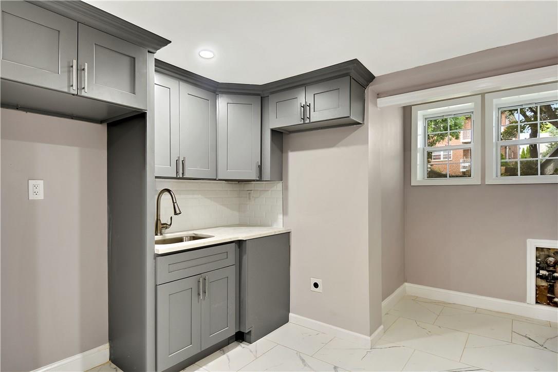 2726 Mickle Avenue Bronx, NY 10469 - Photo 11 of 16 a kitchen with stainless steel appliances granite countertop a refrigerator and a sink