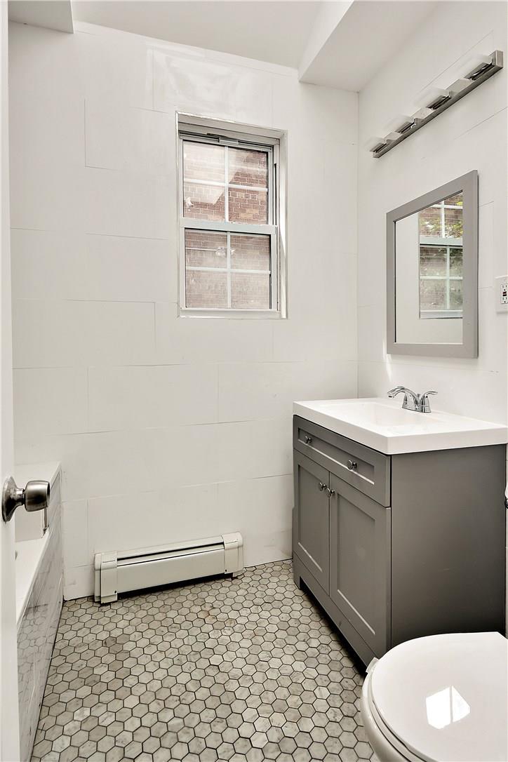 2726 Mickle Avenue Bronx, NY 10469 - Photo 12 of 16 a bathroom with a sink a toilet and a mirror