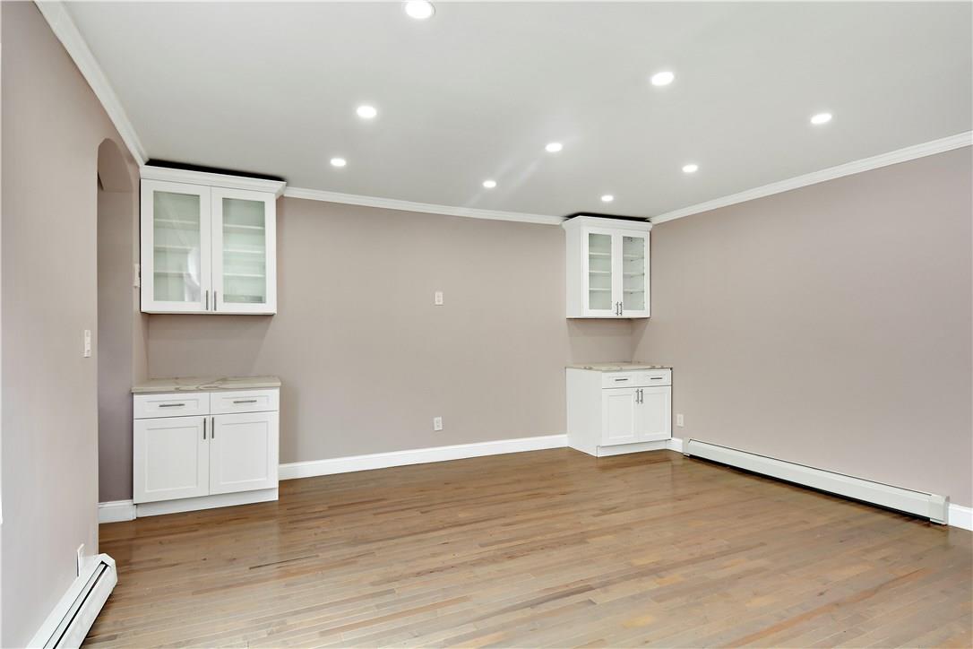 2726 Mickle Avenue Bronx, NY 10469 - Photo 4 of 16 an empty room with wooden floor and windows
