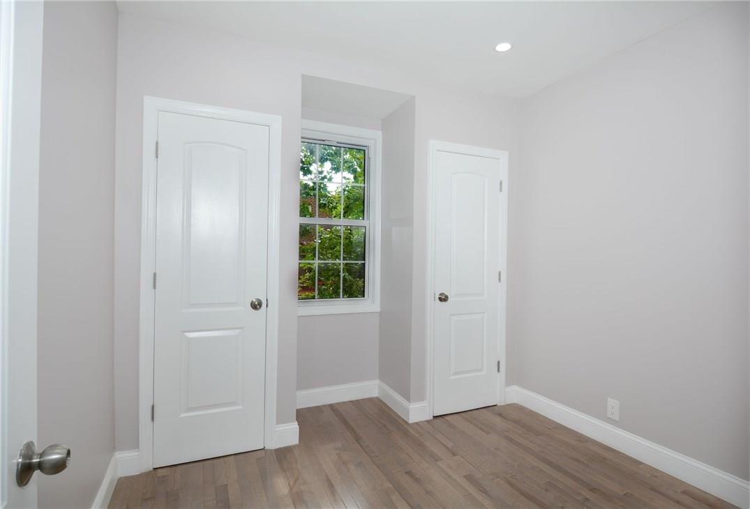 2726 Mickle Avenue Bronx, NY 10469 - Photo 5 of 16 an empty room with wooden floor and windows