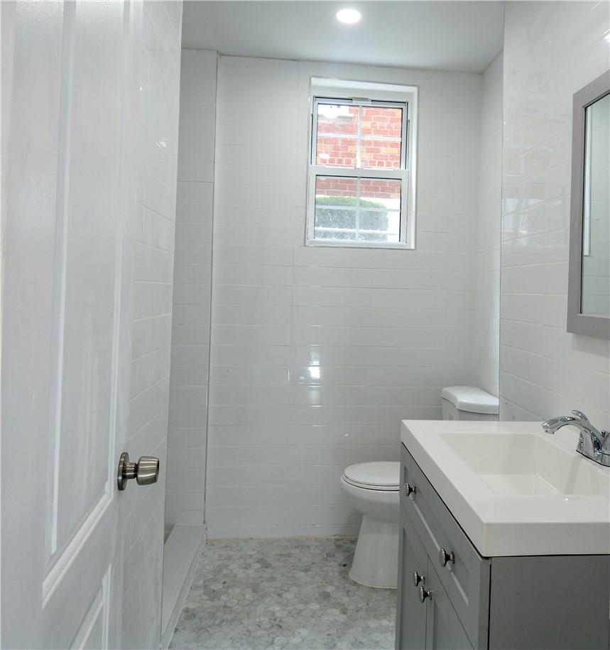 2726 Mickle Avenue Bronx, NY 10469 - Photo 9 of 16 a bathroom with a sink toilet and a mirror