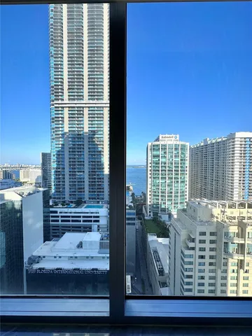 an empty room with closet and a window