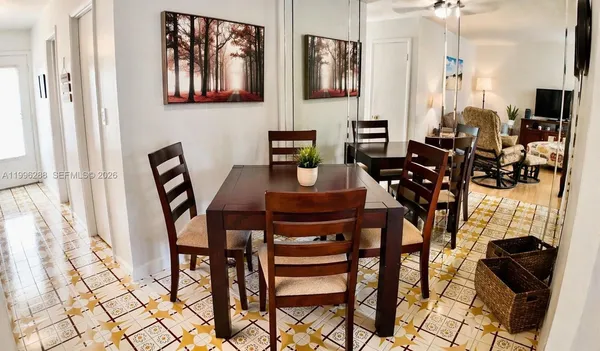 a view of a dining room with furniture and a chandelier
