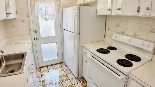 a white refrigerator freezer sitting inside of a kitchen
