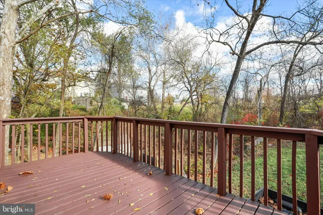 a view of balcony with wooden floor and fence