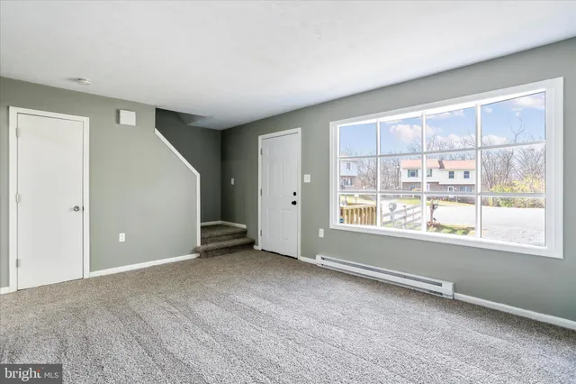 an empty room with windows and closet