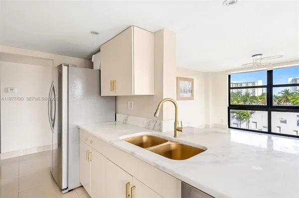 a kitchen with a sink cabinets and a large window