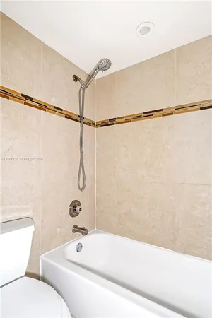 a bathroom with a bathtub and shower