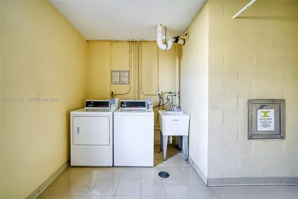 a view of living room kitchen with stainless steel appliances granite countertop furniture and a view of living room