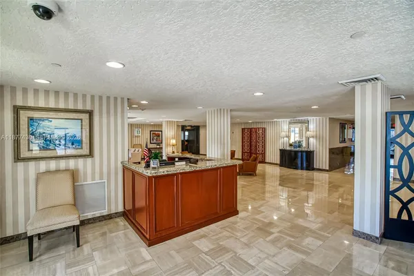 a living room with furniture and large windows
