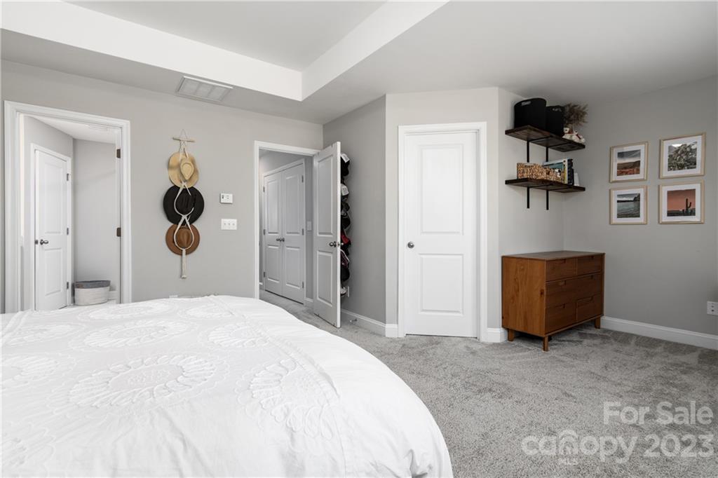 2036 Suttonview Road Fort Mill, SC 29708 - Photo 14 of 37 a bedroom with a large bed and a chandelier