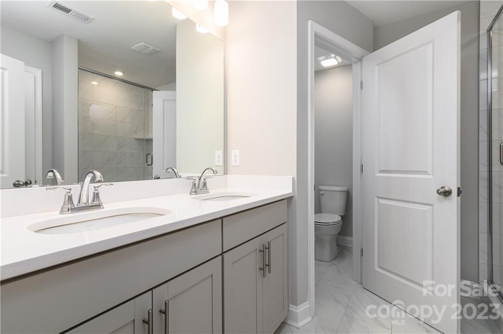 2036 Suttonview Road Fort Mill, SC 29708 - Photo 15 of 37 a bathroom with a double vanity sink mirror and toilet