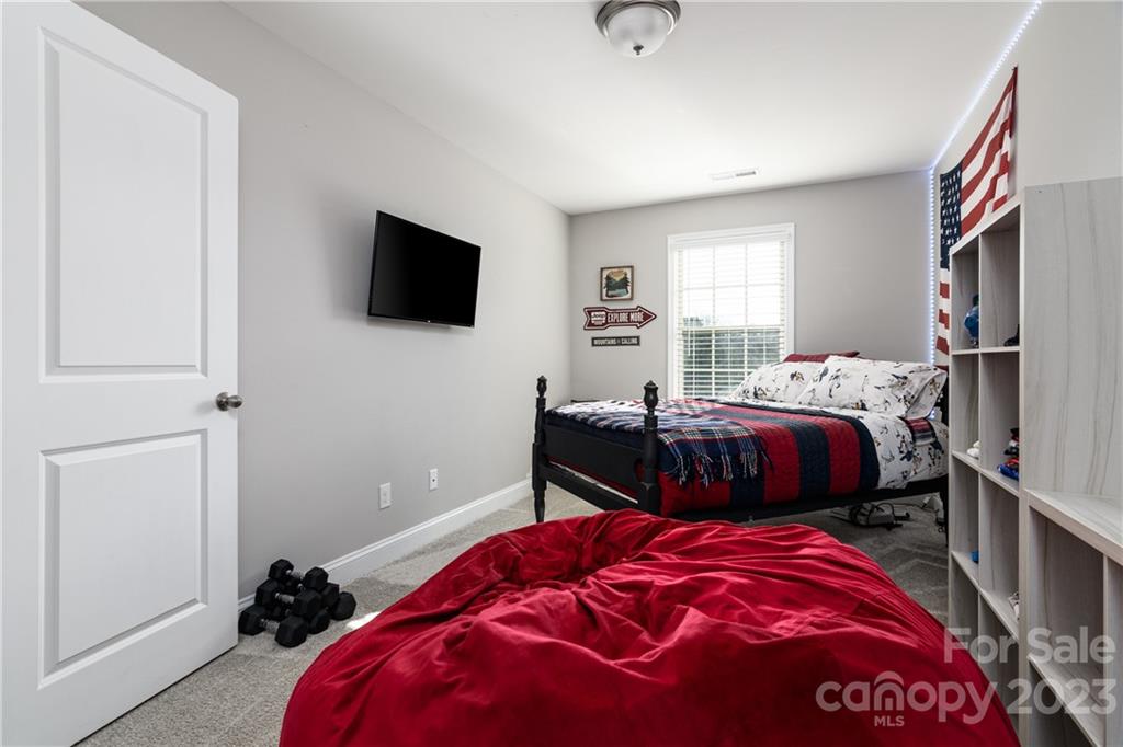2036 Suttonview Road Fort Mill, SC 29708 - Photo 20 of 37 a bedroom with a bed and a flat screen tv