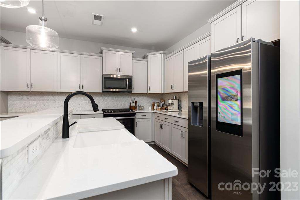 2036 Suttonview Road Fort Mill, SC 29708 - Photo 6 of 37 a kitchen with stainless steel appliances granite countertop a refrigerator a stove a sink and a microwave
