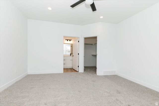 314 North 200 West Logan, UT 84321 - Photo 26 of 37 Unfurnished bedroom featuring a walk in closet, light carpet, recessed lighting, ceiling fan, and connected bathroom