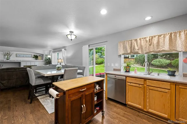 a kitchen with a sink a counter top space and stainless steel appliances